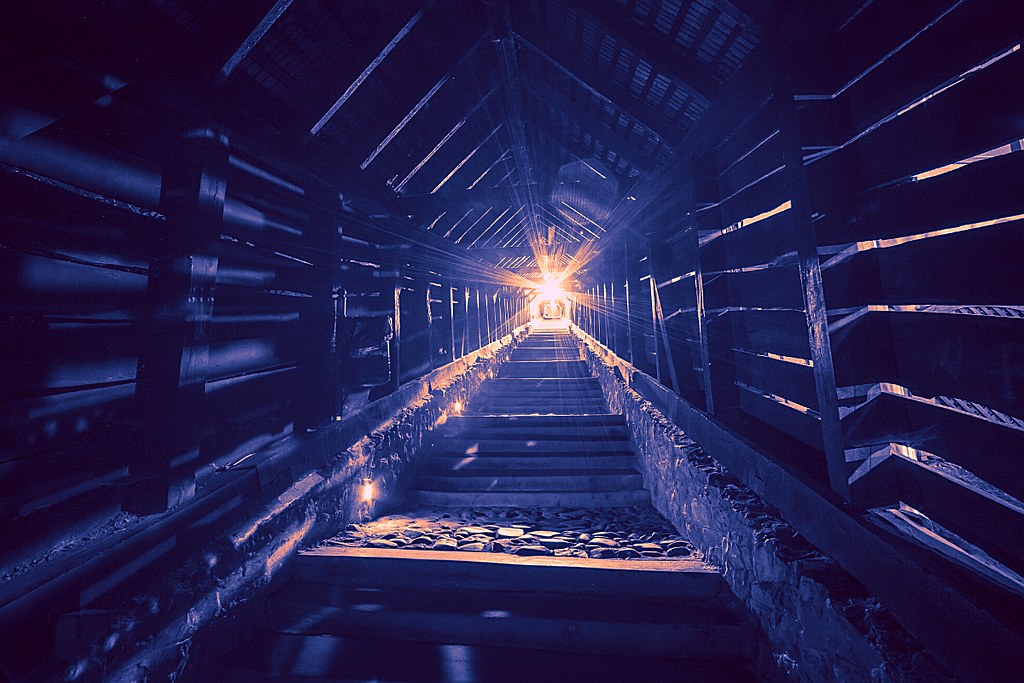 Light streaming into a long dark corridor
