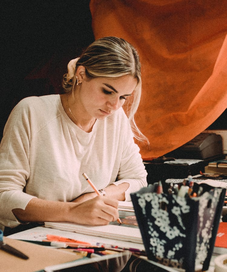 Women-working-at-desk Women sitting at a desk drawing an illustration